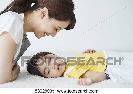 Japanese mother with sleeping kid View Large Photo Image Stock Photography - Japanese mother with sleeping kid. Fotosearch