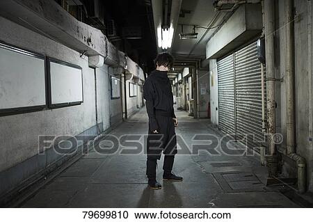 Stock Image - Japanese ninja at night downtown Tokyo. Fotosearch