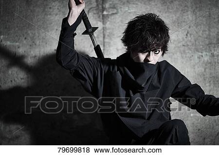 Stock Photo - Japanese ninja at night downtown Tokyo. Fotosearch