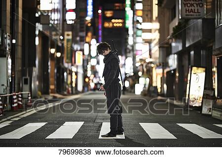 Stock Photo - Japanese ninja at night downtown Tokyo. Fotosearch