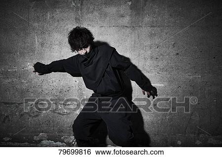 Stock Photograph - Japanese ninja at night downtown Tokyo. Fotosearch
