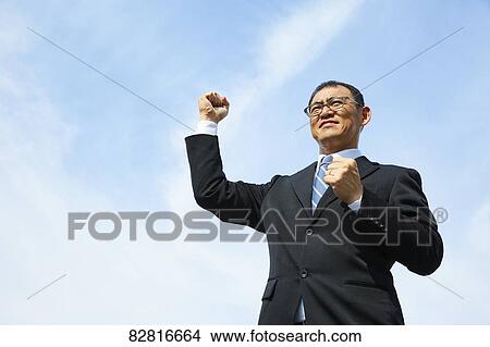 Picture - Japanese salaryman against blue sky. Fotosearch