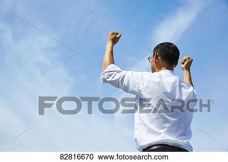 Japanese salaryman against blue sky View Large Photo Image Stock Image - Japanese salaryman against blue sky. Fotosearch
