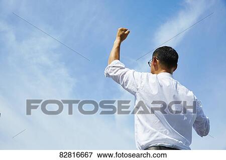 Stock Photo - Japanese salaryman against blue sky. Fotosearch