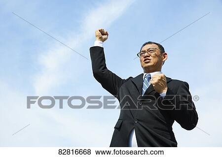 Japanese salaryman against blue sky View Large Photo Image Stock Photo - Japanese salaryman against blue sky. Fotosearch
