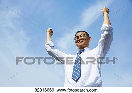 Japanese salaryman against blue sky View Large Photo Image Stock Photo - Japanese salaryman against blue sky. Fotosearch