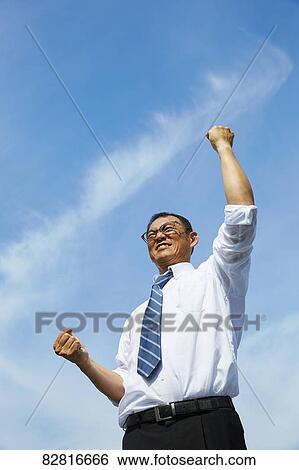 Stock Photograph - Japanese salaryman against blue sky. Fotosearch