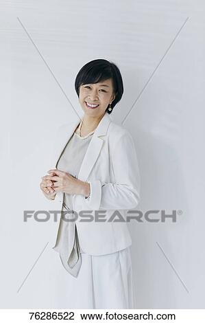 Japanese senior businesswoman against white wall View Large Photo Image Stock Image - Japanese senior businesswoman against white wall. Fotosearch