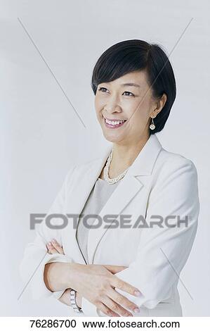 Japanese senior businesswoman against white wall View Large Photo Image Stock Image - Japanese senior businesswoman against white wall. Fotosearch
