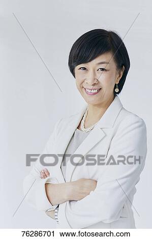 Japanese senior businesswoman against white wall View Large Photo Image Stock Image - Japanese senior businesswoman against white wall. Fotosearch