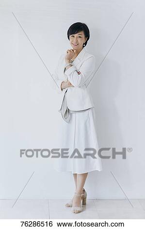 Japanese senior businesswoman against white wall View Large Photo Image Stock Photograph - Japanese senior businesswoman against white wall. Fotosearch