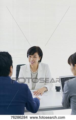 Picture - Japanese senior businesswoman having meeting in the office. Fotosearch