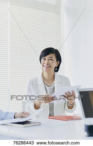 Japanese senior businesswoman having meeting in the office View Large Photo Image Stock Image - Japanese senior businesswoman having meeting in the office. Fotosearch