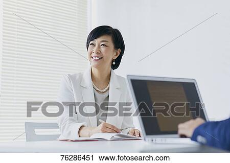 Japanese senior businesswoman having meeting in the office View Large Photo Image Stock Image - Japanese senior businesswoman having meeting in the office. Fotosearch