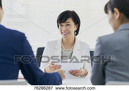 Stock Photo - Japanese senior businesswoman having meeting in the office. Fotosearch