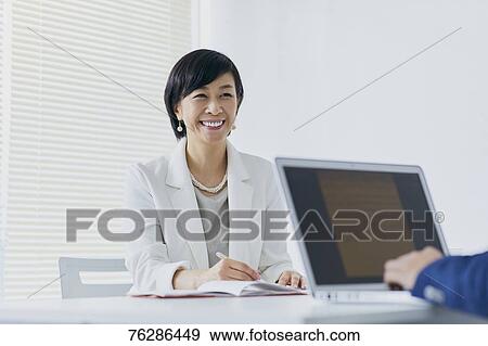 Japanese senior businesswoman having meeting in the office View Large Photo Image Stock Photo - Japanese senior businesswoman having meeting in the office. Fotosearch