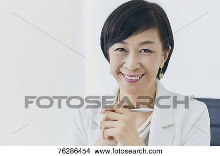 Picture - Japanese senior businesswoman in the office. Fotosearch