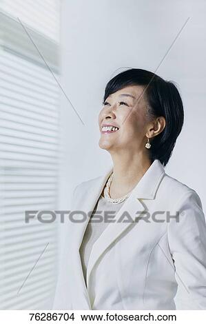 Picture - Japanese senior businesswoman in the office. Fotosearch