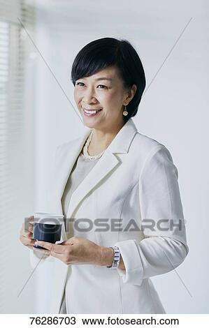 Stock Image - Japanese senior businesswoman in the office. Fotosearch