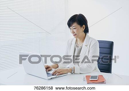 Stock Photo - Japanese senior businesswoman in the office. Fotosearch