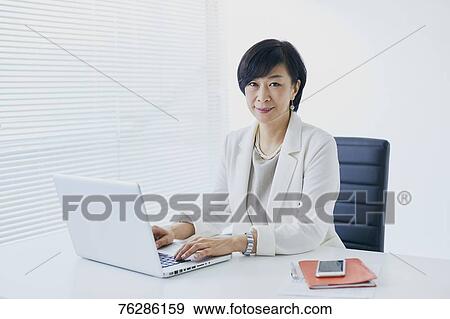 Japanese senior businesswoman in the office View Large Photo Image Stock Photo - Japanese senior businesswoman in the office. Fotosearch