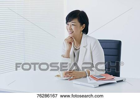 Stock Photo - Japanese senior businesswoman in the office. Fotosearch