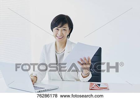 Stock Photo - Japanese senior businesswoman in the office. Fotosearch