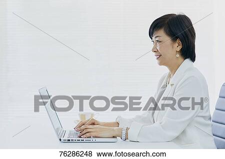Japanese senior businesswoman in the office View Large Photo Image Stock Photo - Japanese senior businesswoman in the office. Fotosearch