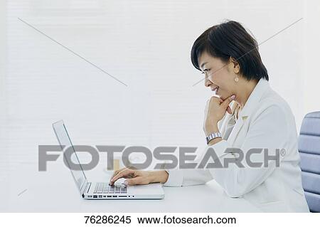 Stock Photography - Japanese senior businesswoman in the office. Fotosearch
