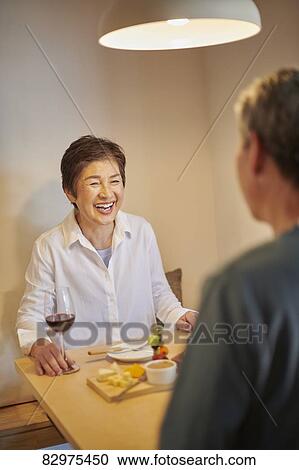 Stock Image - Japanese senior couple dining. Fotosearch