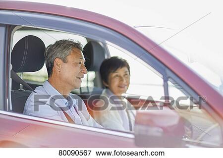 Stock Photo - Japanese senior couple driving. Fotosearch