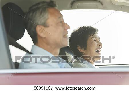 Stock Photo - Japanese senior couple driving. Fotosearch