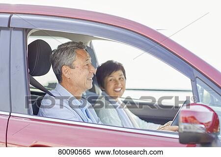 Stock Photography - Japanese senior couple driving. Fotosearch