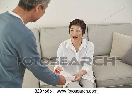 Japanese senior couple exchanging gifts View Large Photo Image Stock Image - Japanese senior couple exchanging gifts. Fotosearch