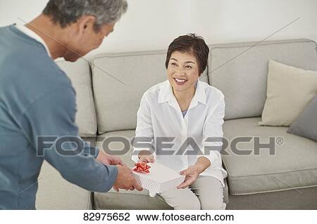 Japanese senior couple exchanging gifts View Large Photo Image Stock Image - Japanese senior couple exchanging gifts. Fotosearch