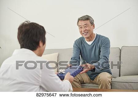 Japanese senior couple exchanging gifts View Large Photo Image Stock Photo - Japanese senior couple exchanging gifts. Fotosearch