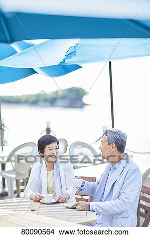 Japanese senior couple having a drink by the sea View Large Photo Image Picture - Japanese senior couple having a drink by the sea. Fotosearch