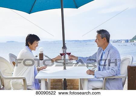 Japanese senior couple having a drink by the sea View Large Photo Image Stock Image - Japanese senior couple having a drink by the sea. Fotosearch