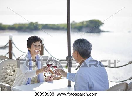 Japanese senior couple having a drink by the sea View Large Photo Image Stock Image - Japanese senior couple having a drink by the sea. Fotosearch