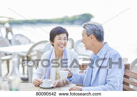 Japanese senior couple having a drink by the sea View Large Photo Image Stock Image - Japanese senior couple having a drink by the sea. Fotosearch