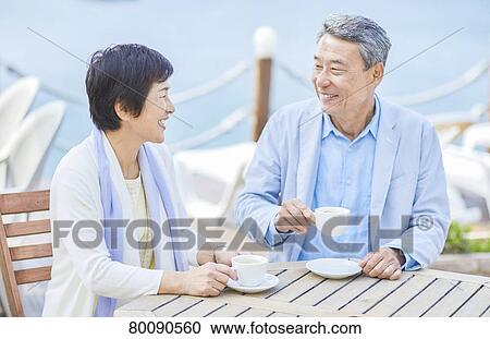 Japanese senior couple having a drink by the sea View Large Photo Image Stock Image - Japanese senior couple having a drink by the sea. Fotosearch