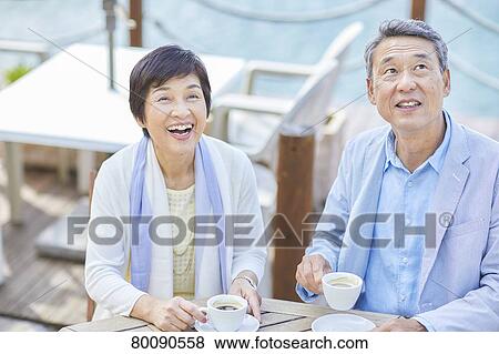 Japanese senior couple having a drink by the sea View Large Photo Image Stock Photo - Japanese senior couple having a drink by the sea. Fotosearch