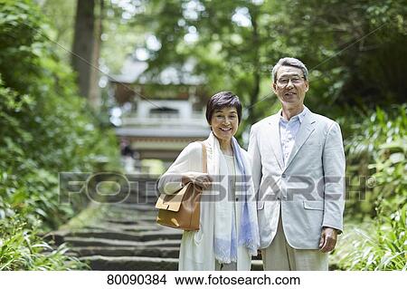 Picture - Japanese senior couple having fun at traditional inn. Fotosearch