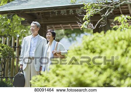 Picture - Japanese senior couple having fun at traditional inn. Fotosearch