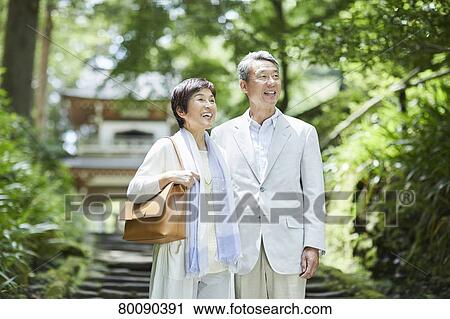 Stock Image - Japanese senior couple having fun at traditional inn. Fotosearch