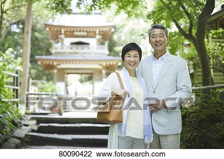 Stock Image - Japanese senior couple having fun at traditional inn. Fotosearch