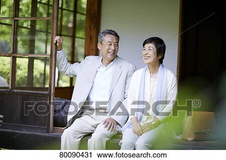 Stock Image - Japanese senior couple having fun at traditional inn. Fotosearch