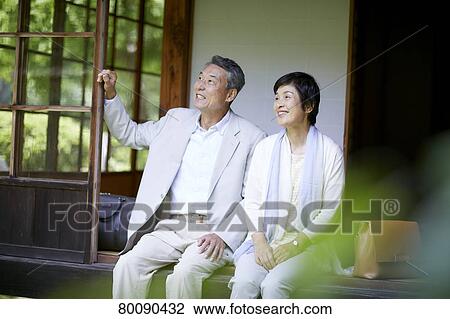 Stock Image - Japanese senior couple having fun at traditional inn. Fotosearch