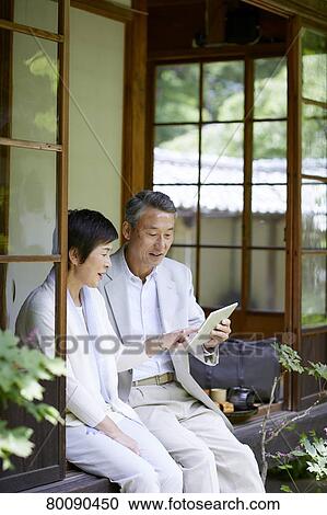 Japanese senior couple having fun at traditional inn View Large Photo Image Stock Image - Japanese senior couple having fun at traditional inn. Fotosearch