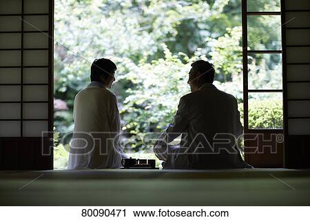 Stock Image - Japanese senior couple having fun at traditional inn. Fotosearch
